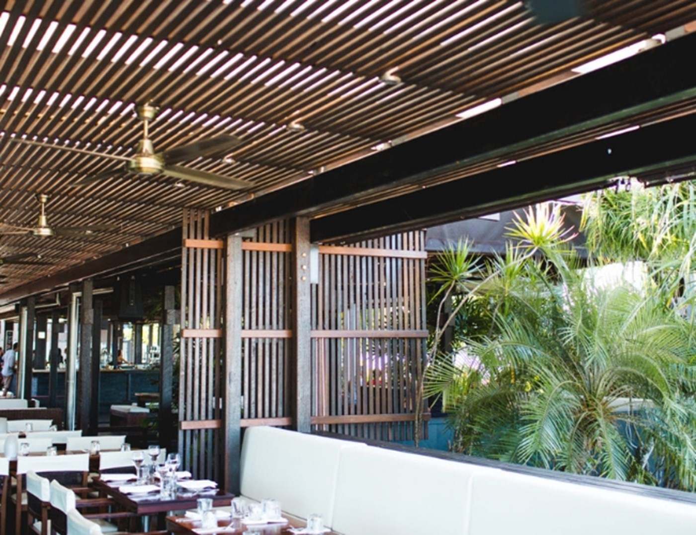Exterior dining area with wooden slat style walls and ceiling