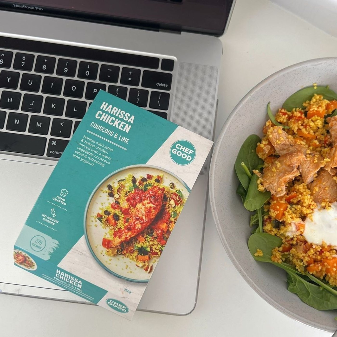 A ready-made meal of harissa chicken, sitting on a laptop, by Chefgood.