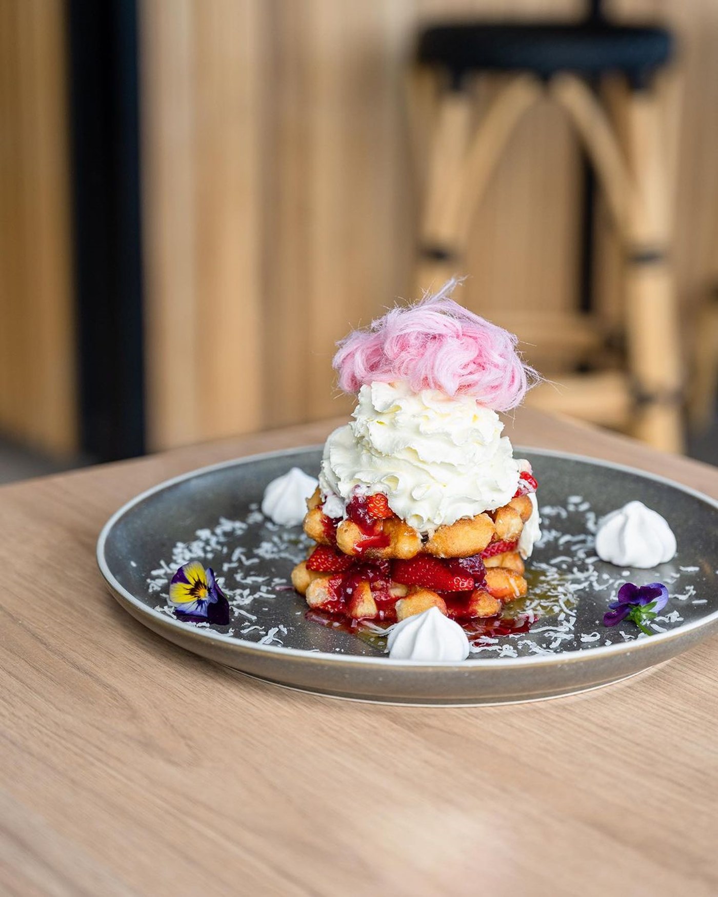 A pavlova waffle with whipped cream, meringue, berries and fairy floss at Piccolo Me Parramatta