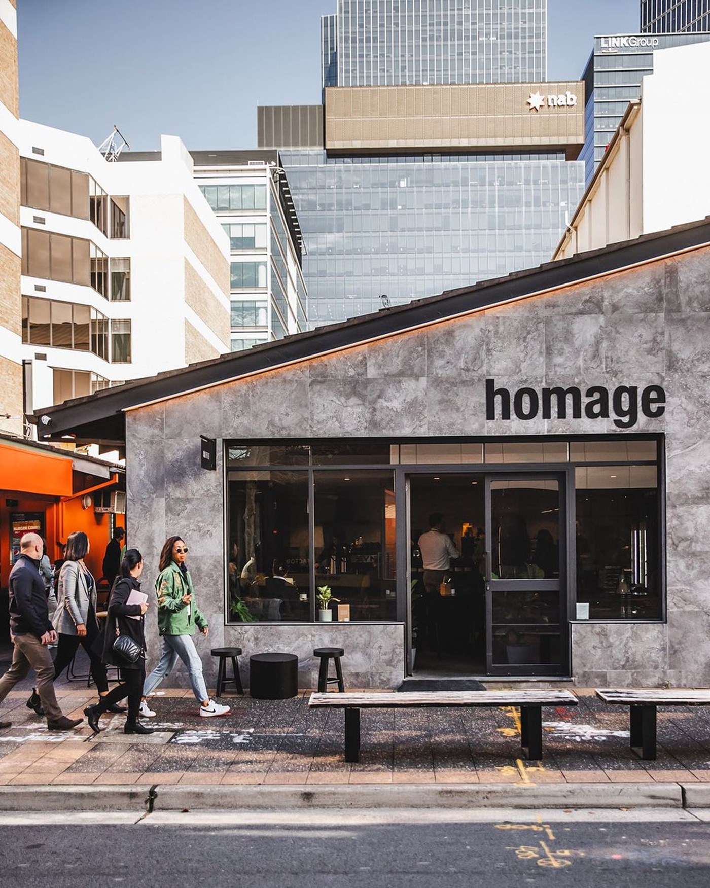 Exterior and front of café Homage in Parramatta with concrete grey exterior