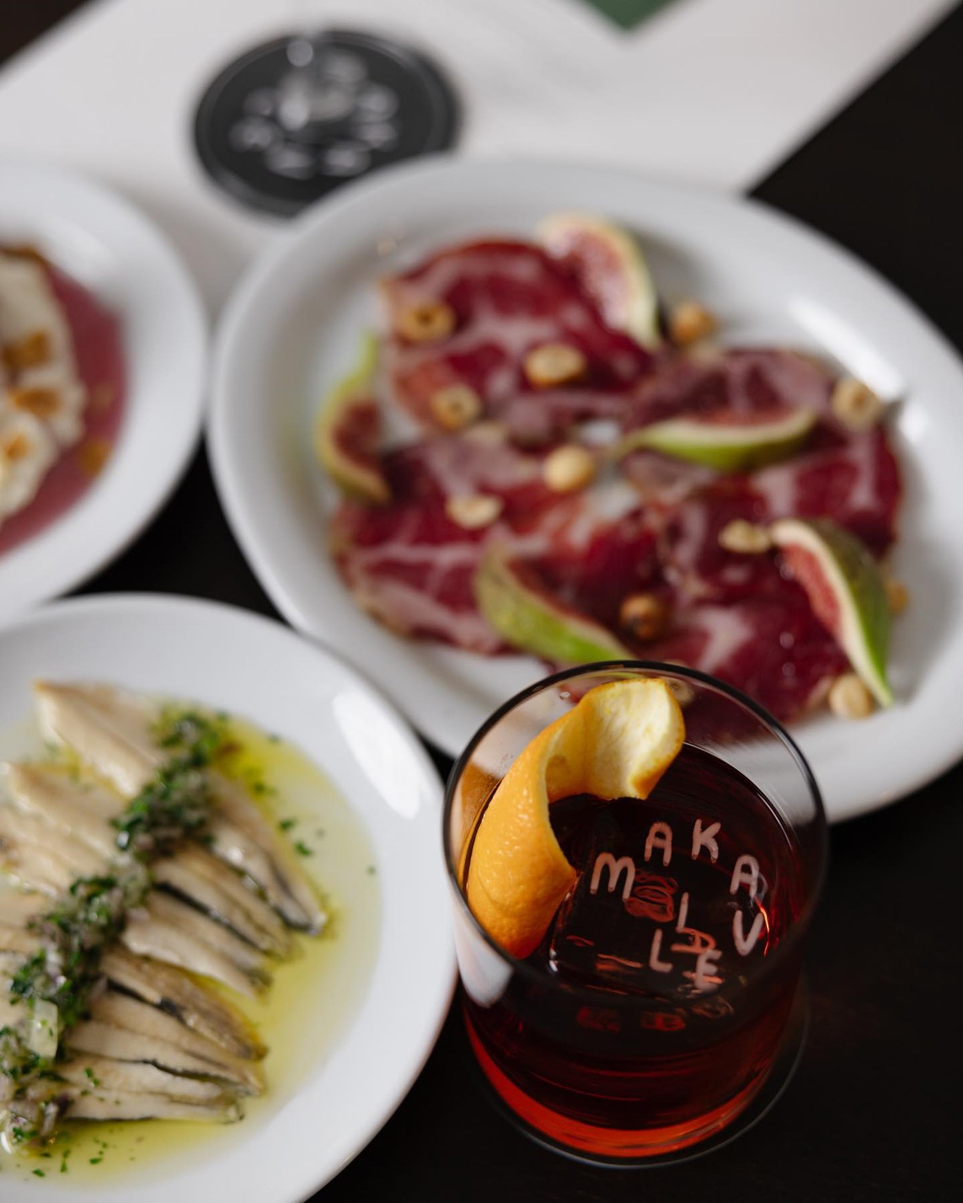 A negroni and assorted tapas plates at Makaveli 