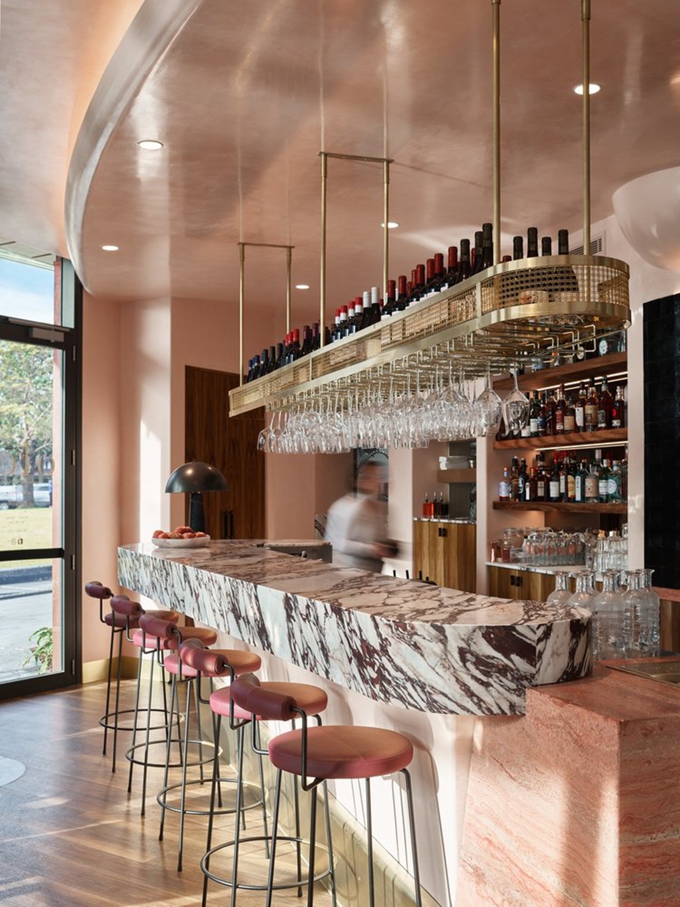 The pink, marble and leather interiors of Olea Restaurant. 