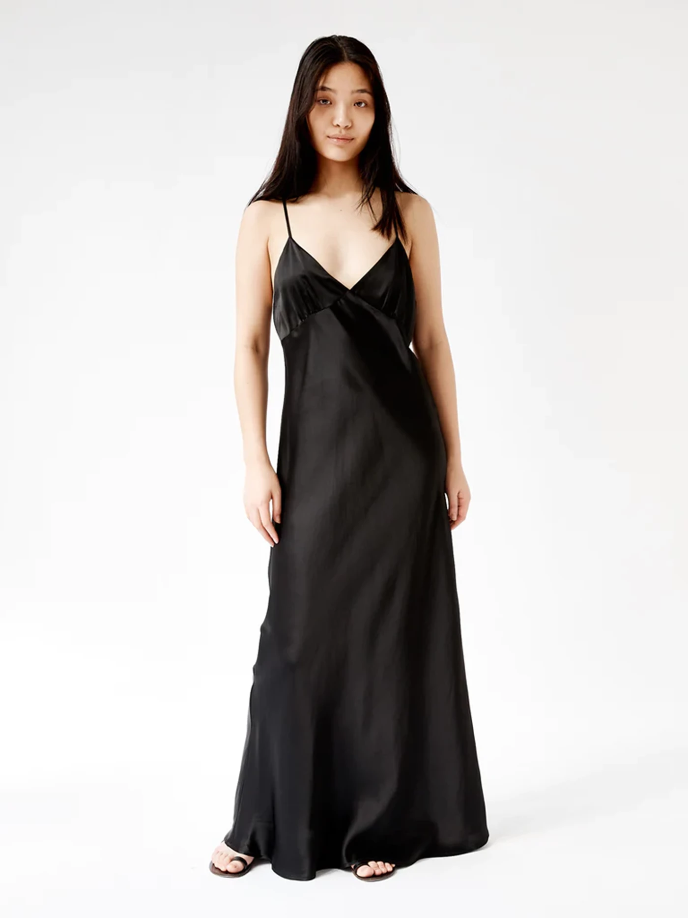 A woman in a black slip night gown.