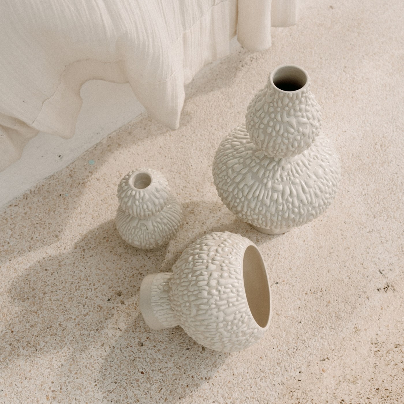 Decorative Vases Australia: Three white textured vases of various sizes and shapes from Marloe Marloe 