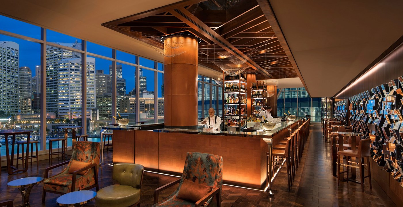 The opulent Champagne Bar within Sofitel Darling Harbour featuring floor to ceiling windows looking out over the water 