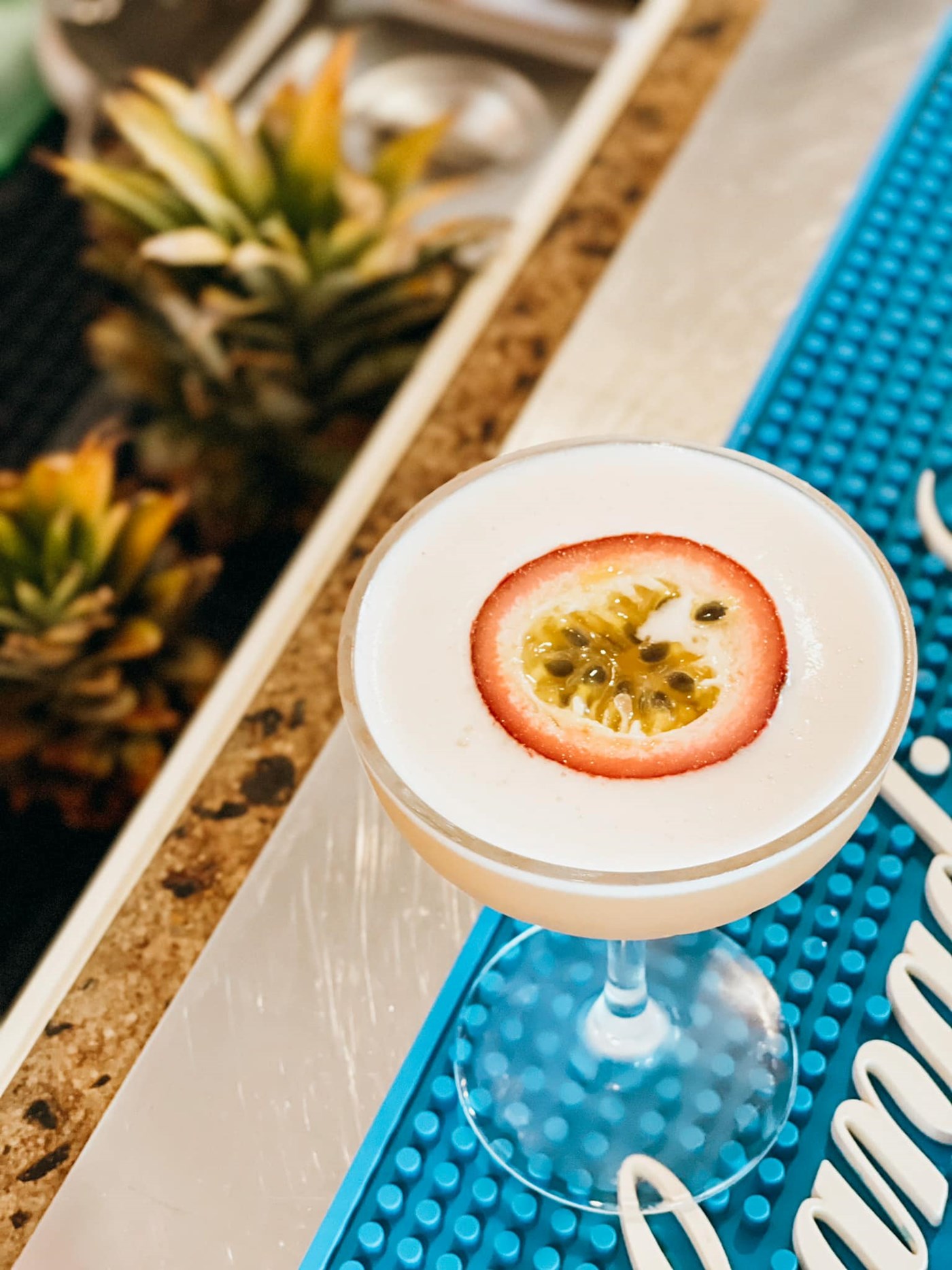 Passionfruit martini on a blue bar mat
