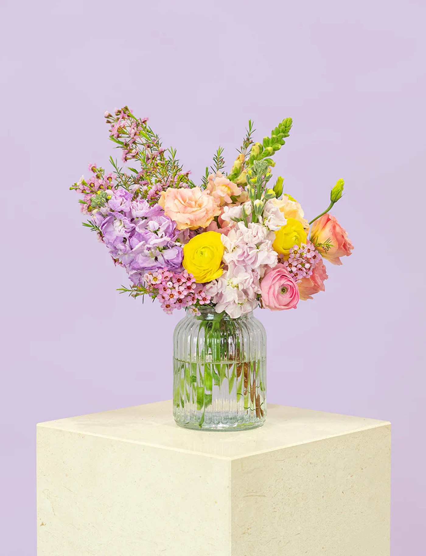 A clear vase filled with fresh and colourful flowers from Daily Blooms