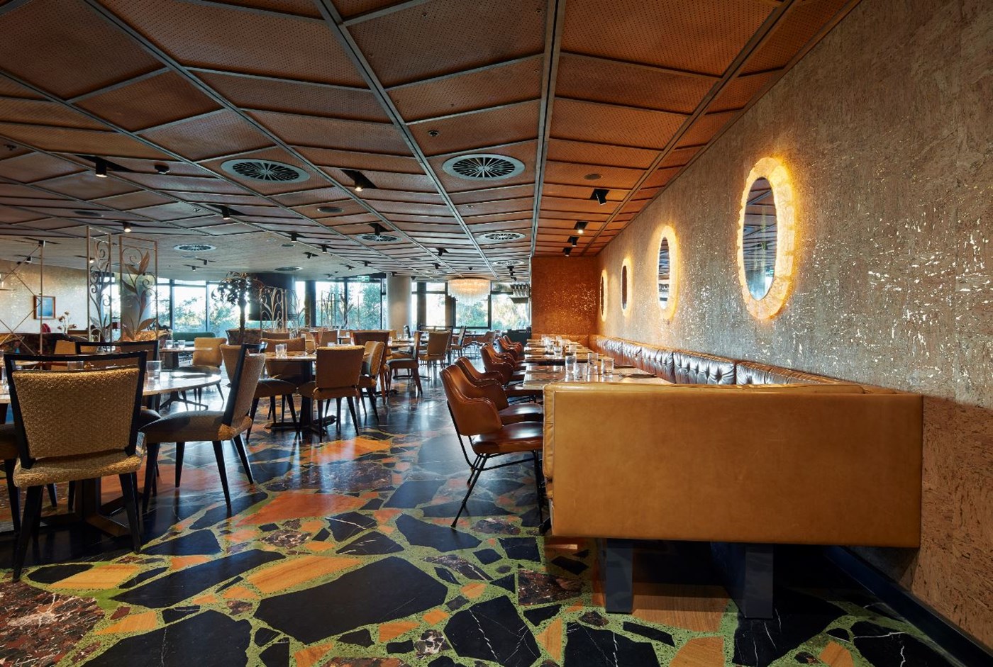 Interior of Monster Kitchen and Bar Canberra featuring mosaic tiles and leather booths