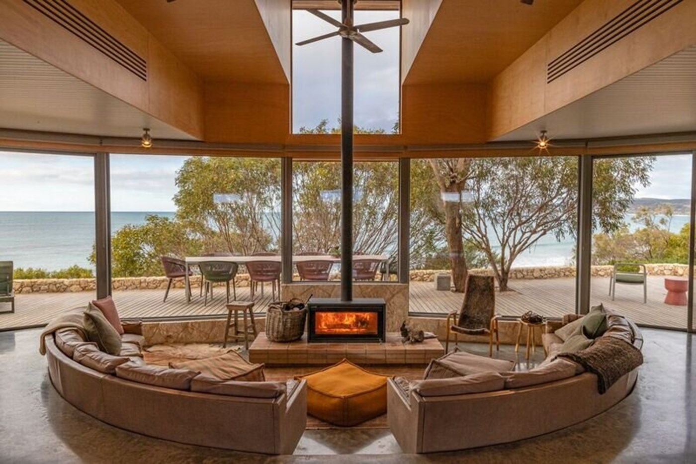Large living room with circular couch and floor-to-ceiling windows at Dune Kangaroo Island