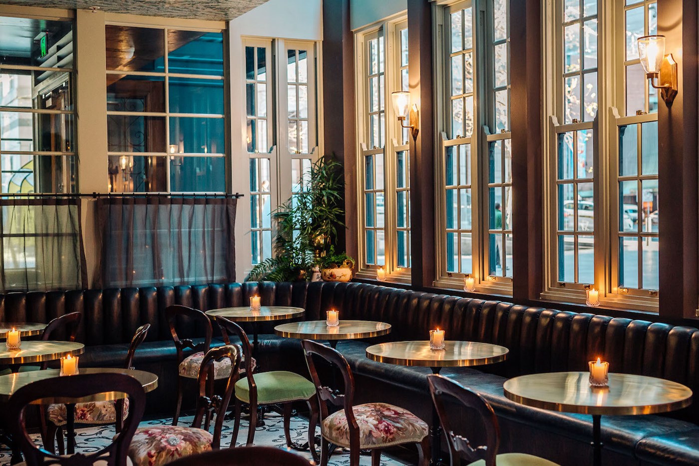 The French-inspired interiors of Kittyhawk featuring candles on each of the round tables 
