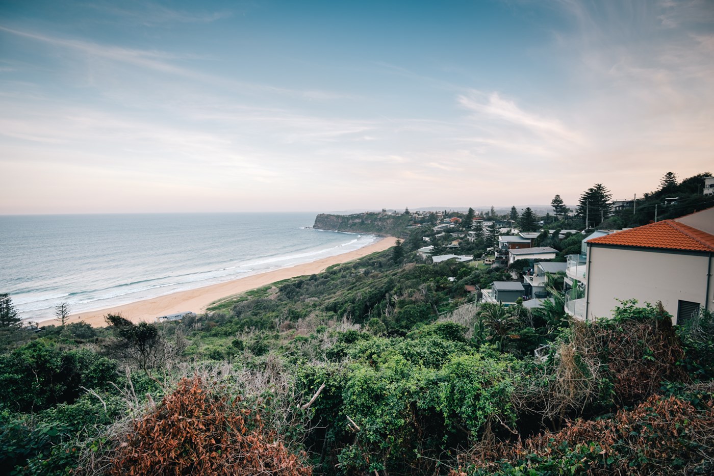 Residential homes overlook the coastline of Bungan Beach. 