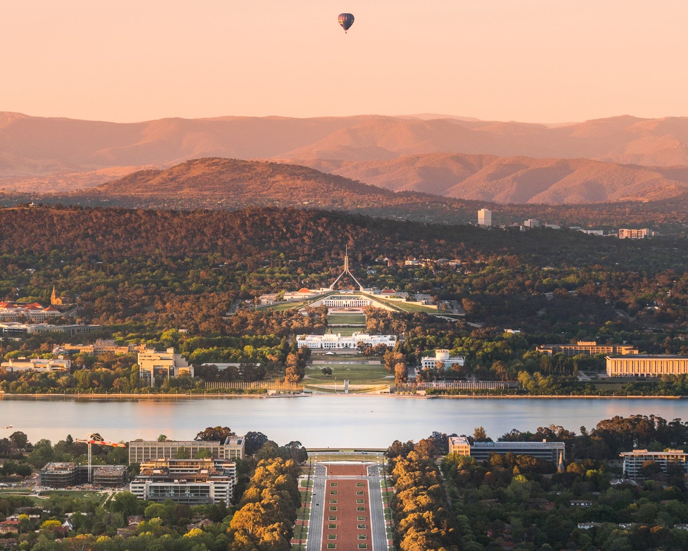 The aerial view of Canberra at sunset, showing Parliament House.