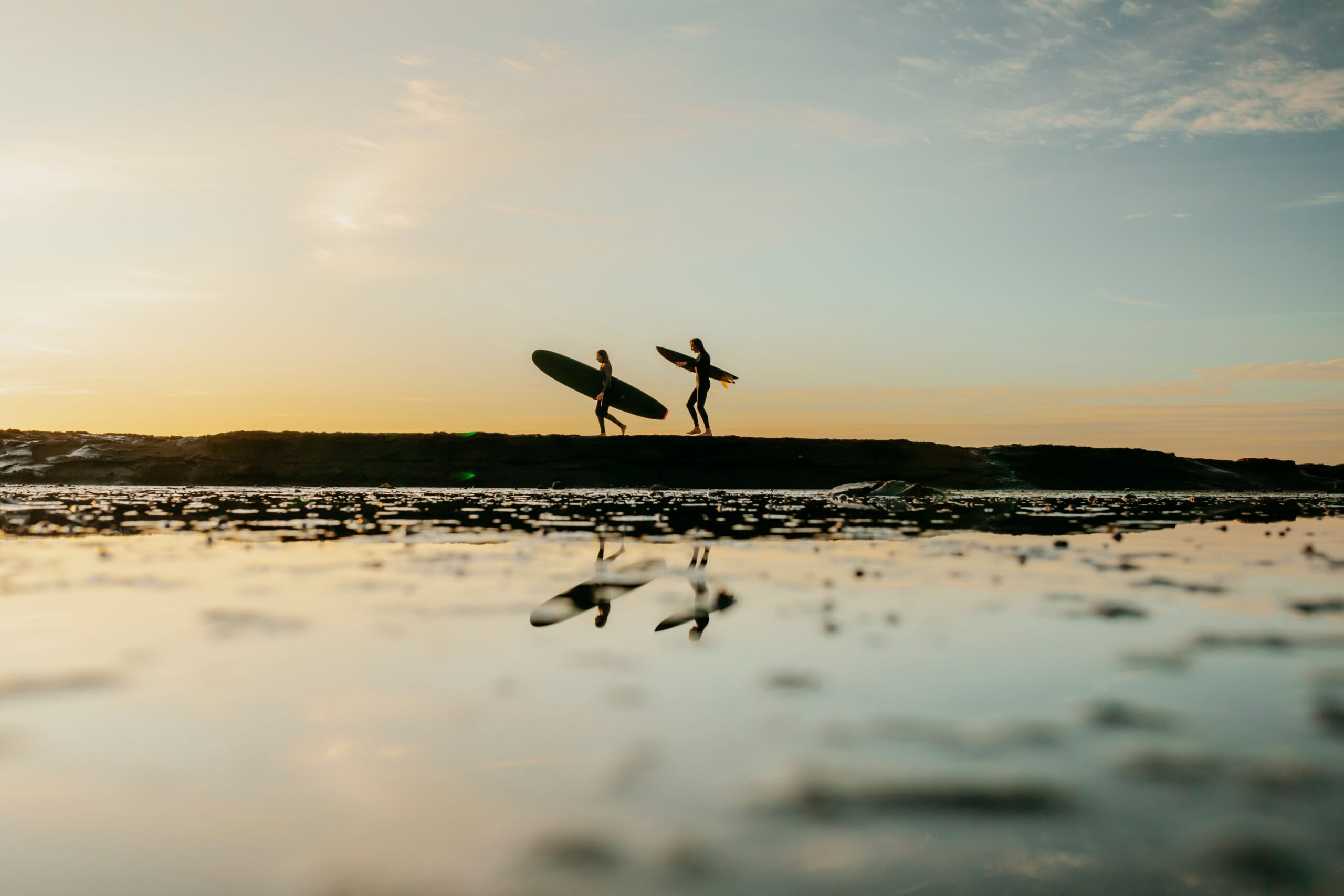 People enjoying a sunset surf at Mollymook, South Coast, NSW. (Image Credit: Destination NSW)