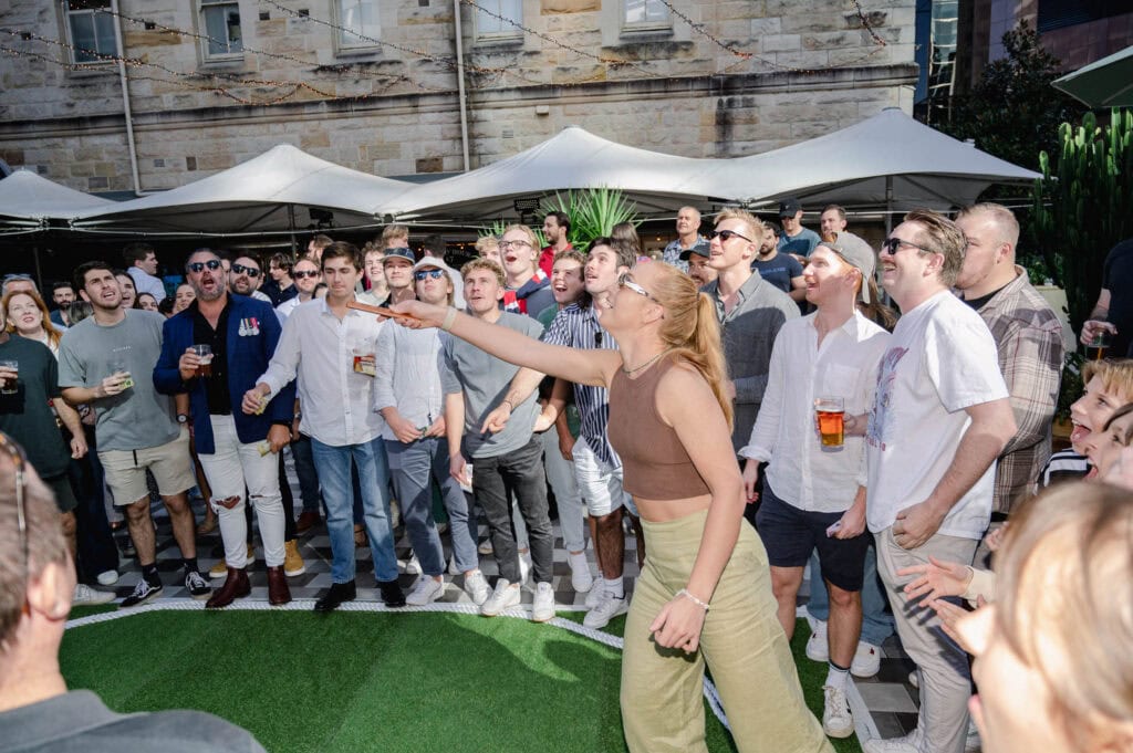 A woman plays two-up on Anzac Day at Greenwood Hotel in North Sydney