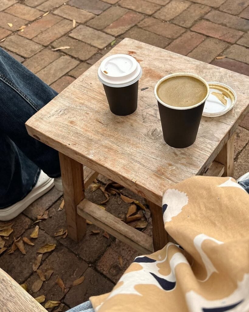 A coffee and a cookie on a cafe table