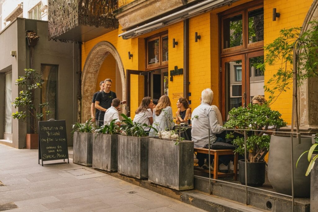 Outdoor dining terrace with yellow brick facade at Yellow restaurant Potts Point Sydney