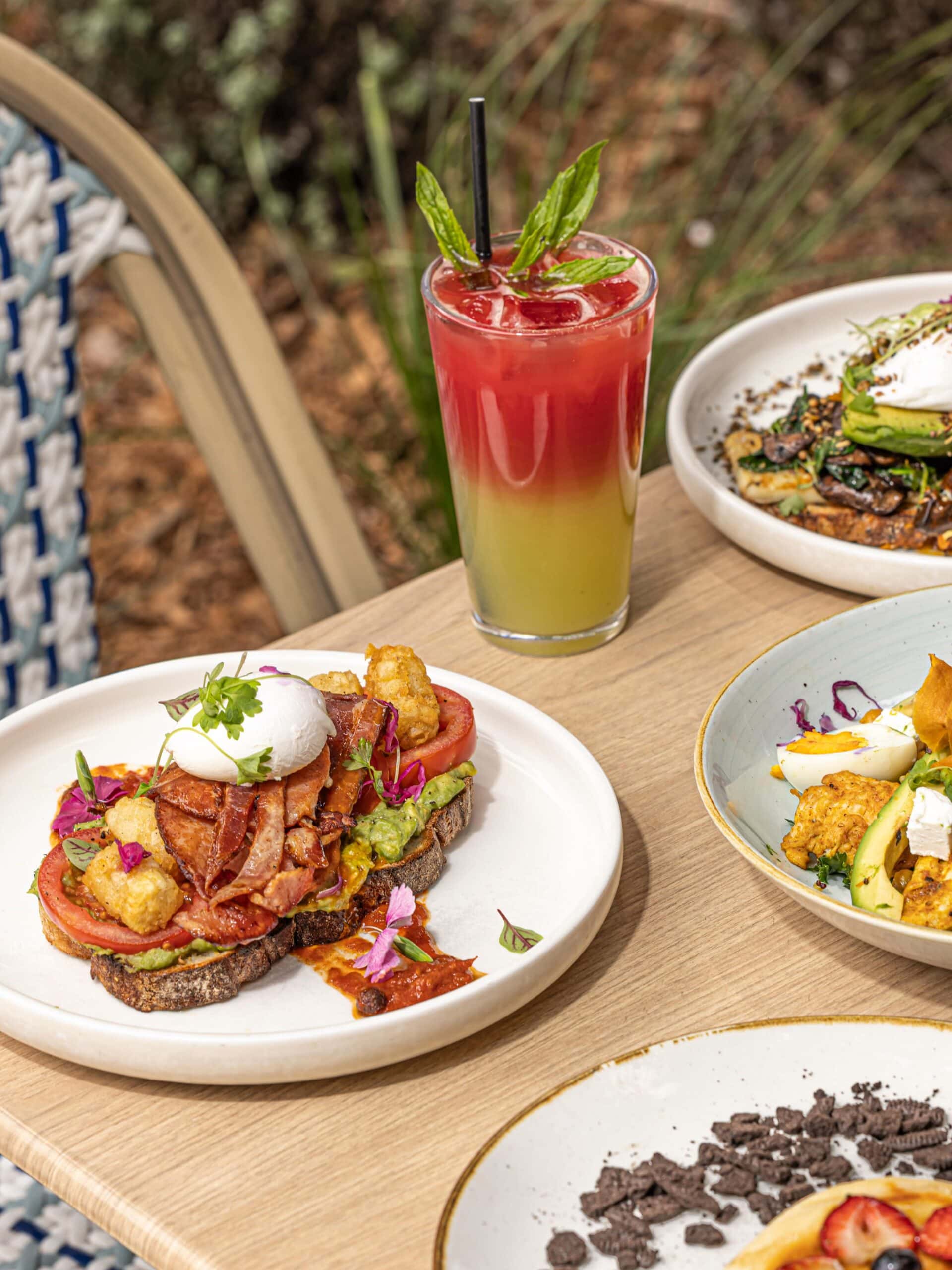 Brunch spread with bacon and avocado toast and iced drink at Avenue Road Cafe Mosman Sydney