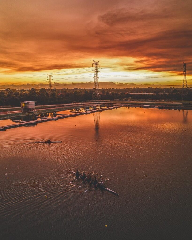 People rowing at sunset Champion Lakes Regatta Centre