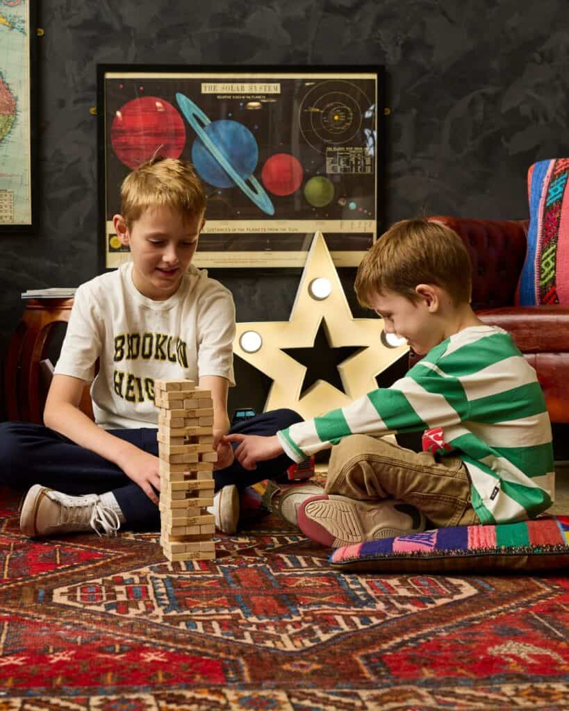 Two children playing jenga on the carpet at Chuck & Sons Breing Co in St Peters.