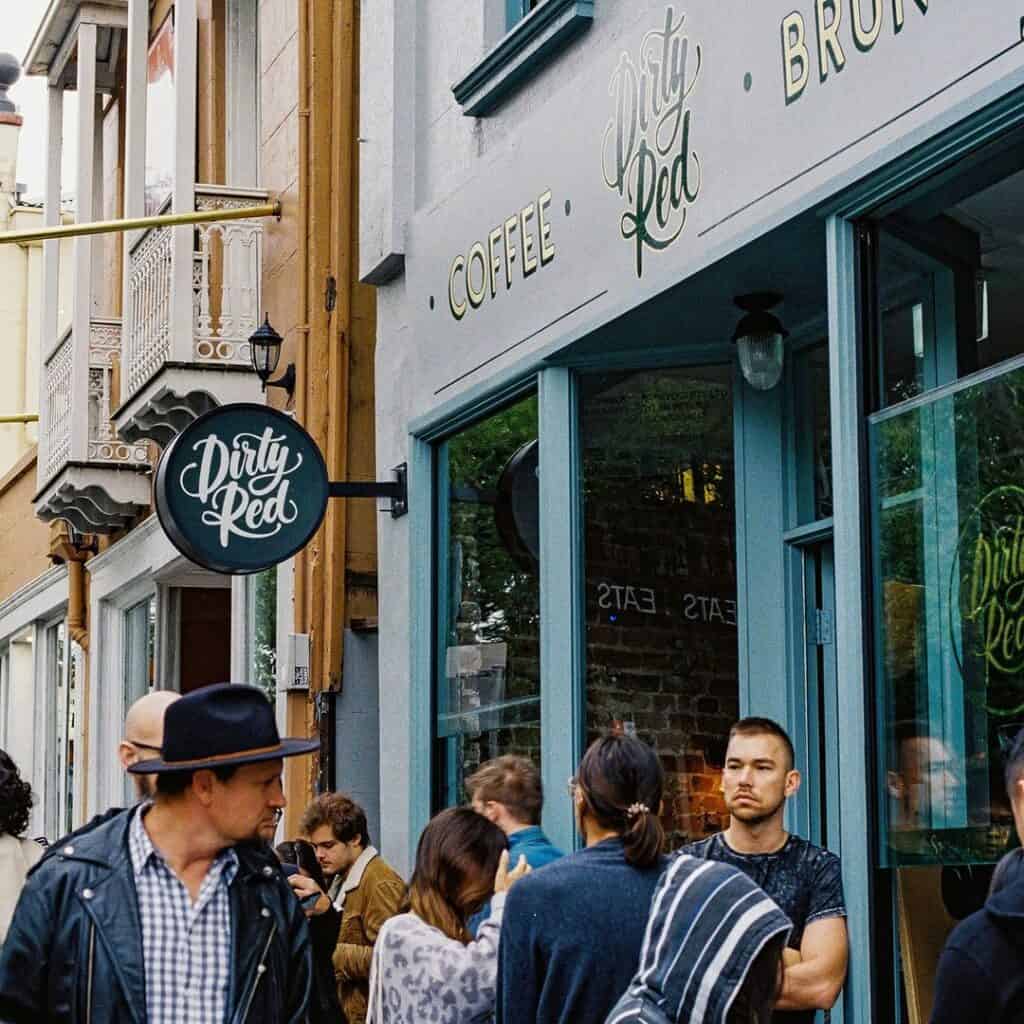 Pedestrians outside a cafe in Glebe.