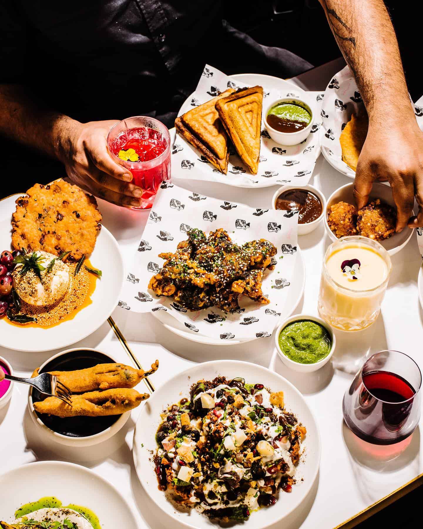 A table full of Indian fusion dishes at flyover fritterie 