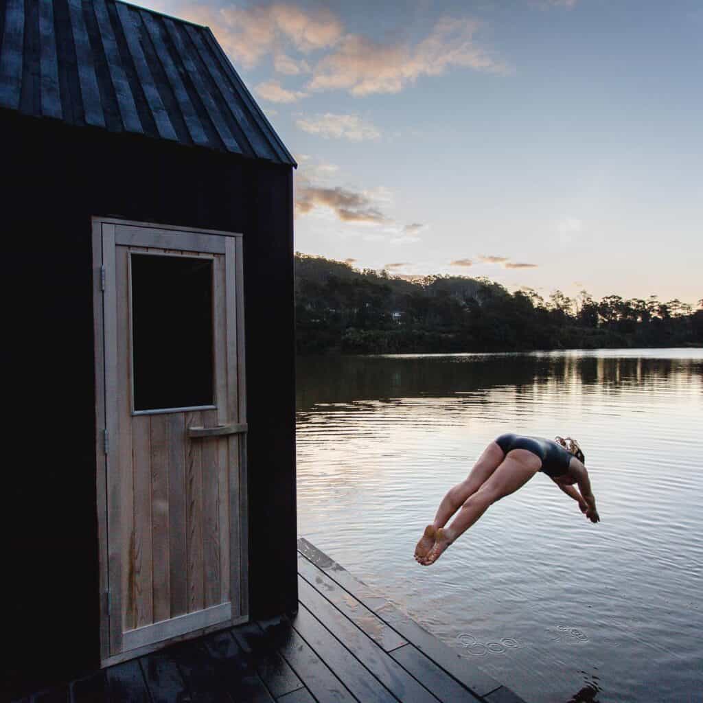 derby floating sauna with woman diving into the water
