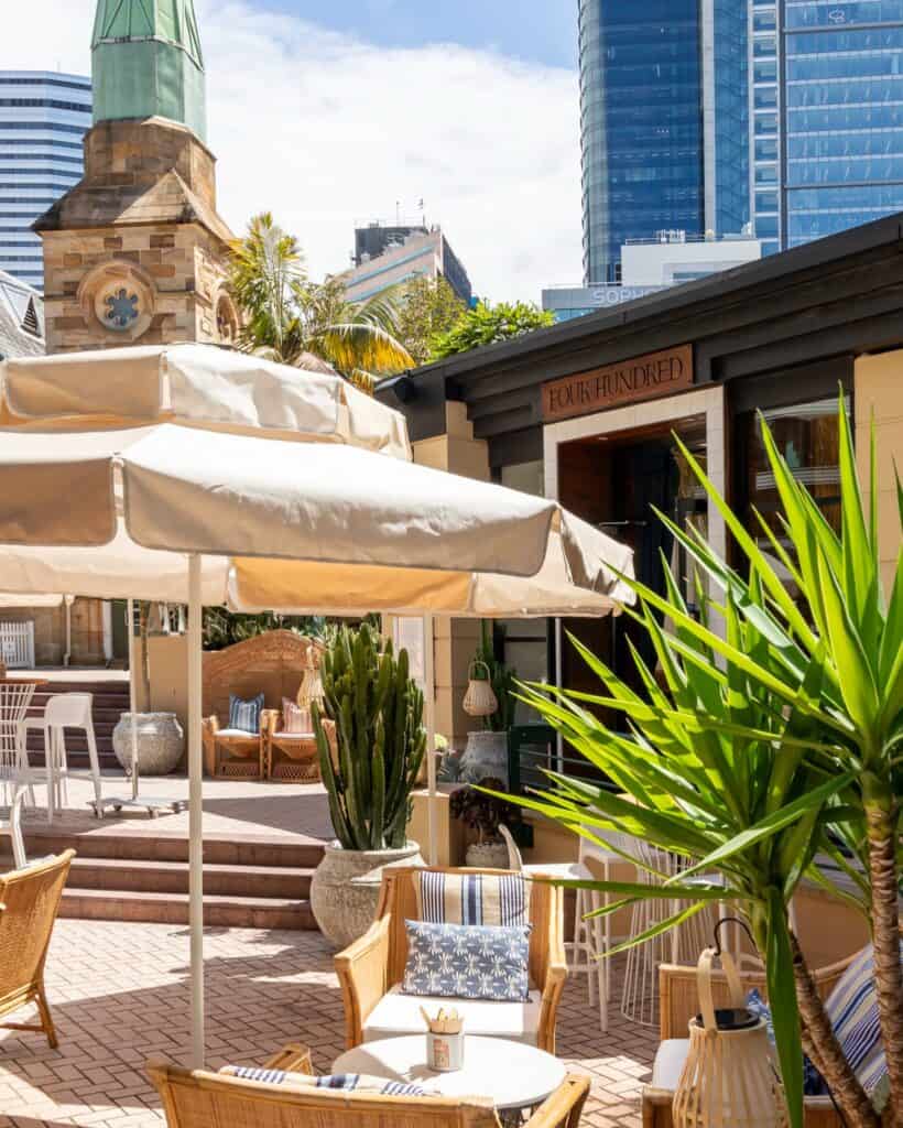 An umbrella and tables amidst the backdrop of North Sydney.