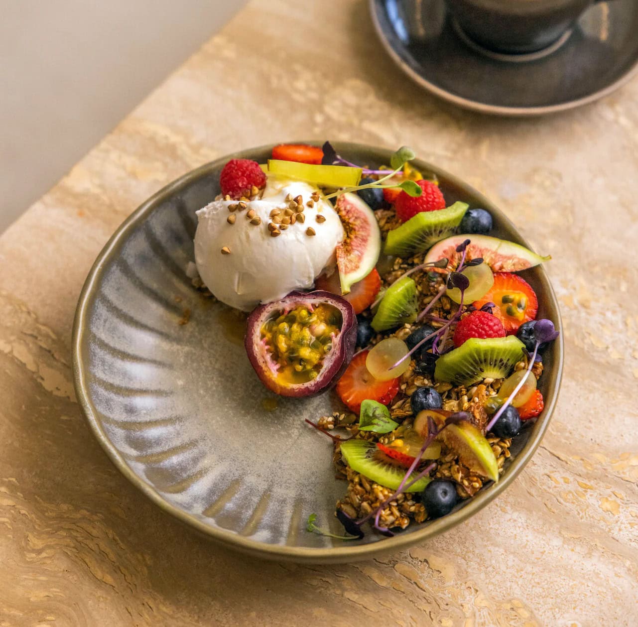 Granola bowl with fresh fruit, passionfruit and yoghurt at Niche Mosman Sydney