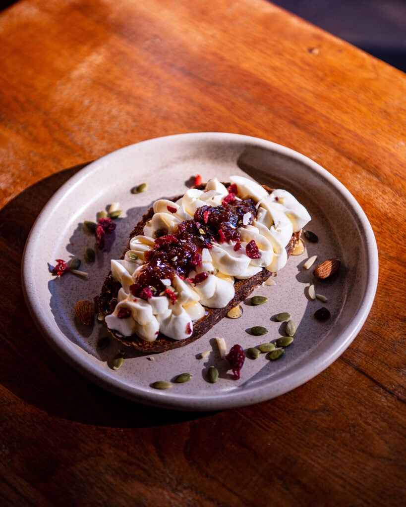 Ricotta toast with berry jam and seeds on sourdough at Il Palio Mosman Sydney