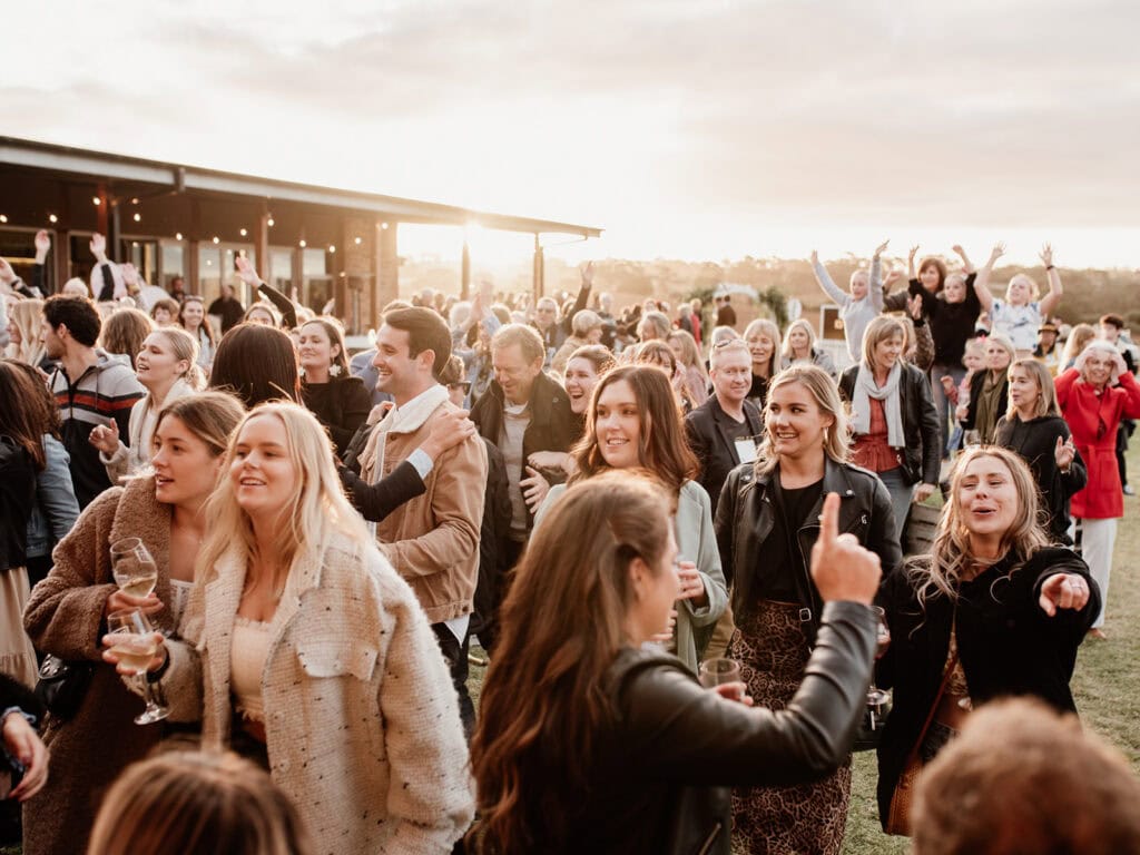 A crowd celebrating and drinking wine during Clare Valley Gourmet Week