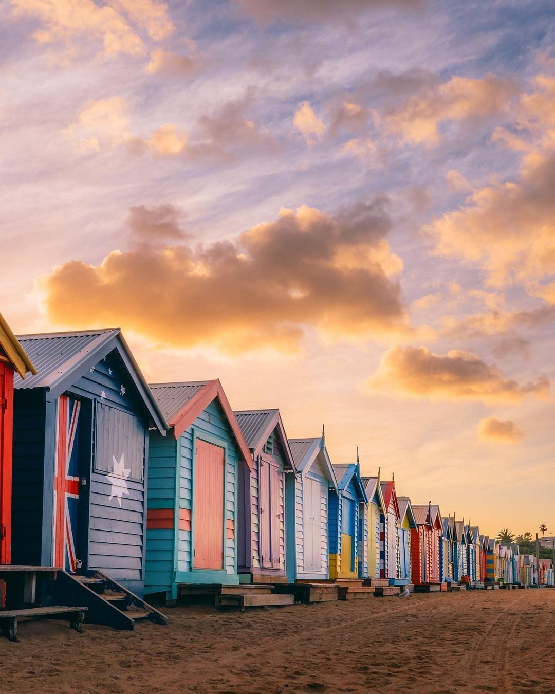 A pastel sunrise over the iconic Brighton Bathing Boxes @ashhughesphotos #VisitMelbourne #StayCloseGoFurther