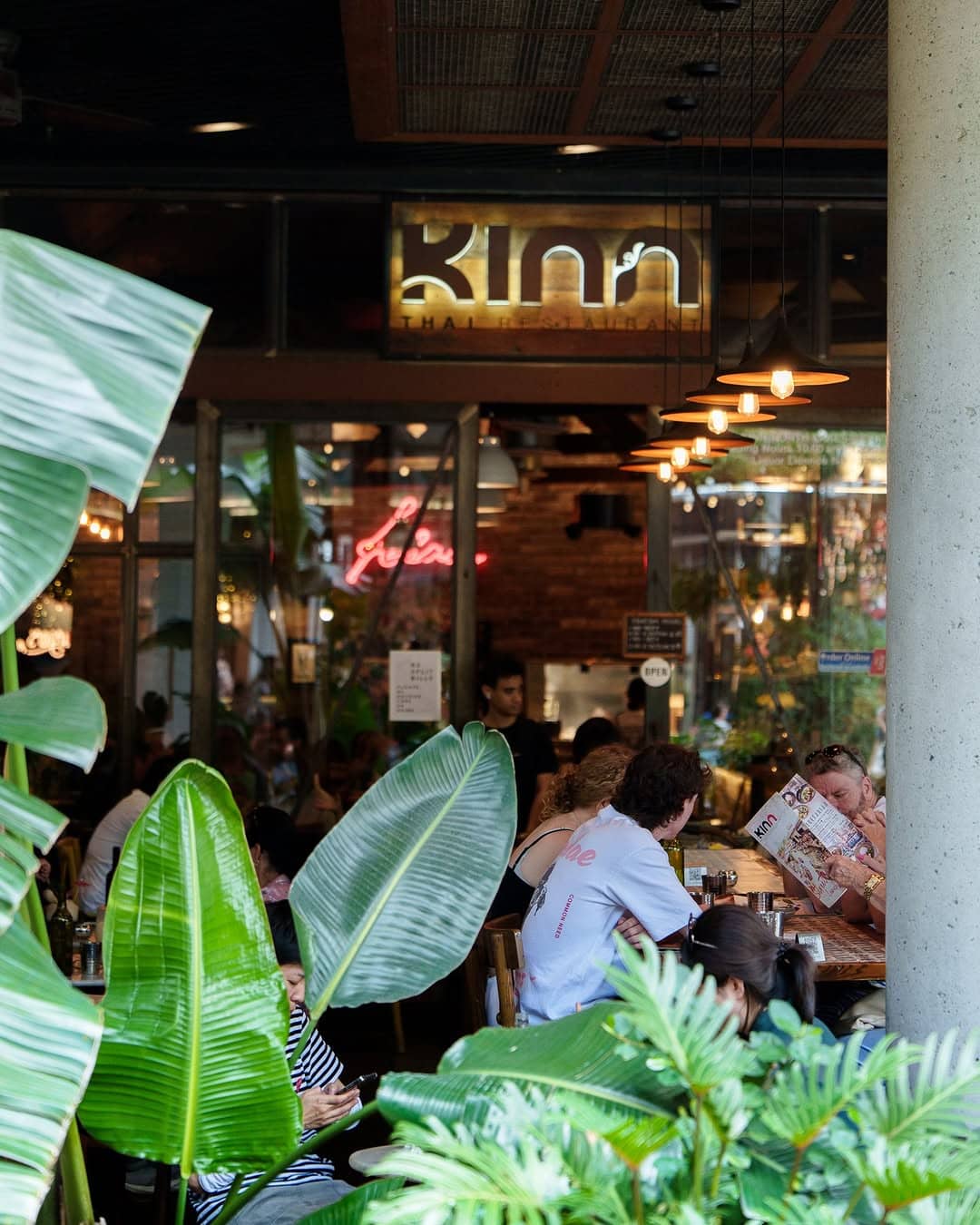 Leafy exterior and al fresco dining area of a Thai restaurant