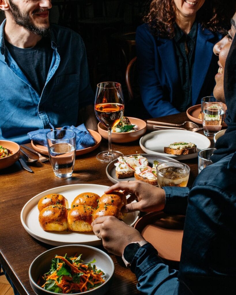 A group of friends enjoying a variety of dishes from kyiv social. 