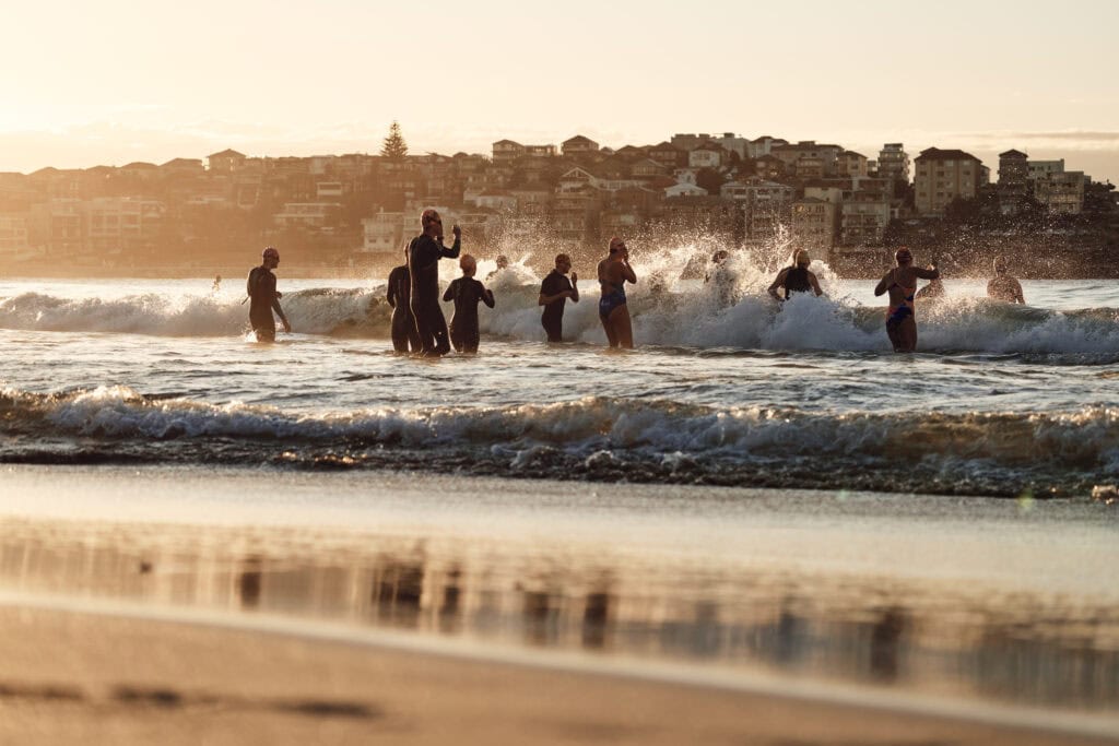 Swimmers heading out into the ocean from Bondi Beach, Sydney. (Image Credit: Destination NSW.)