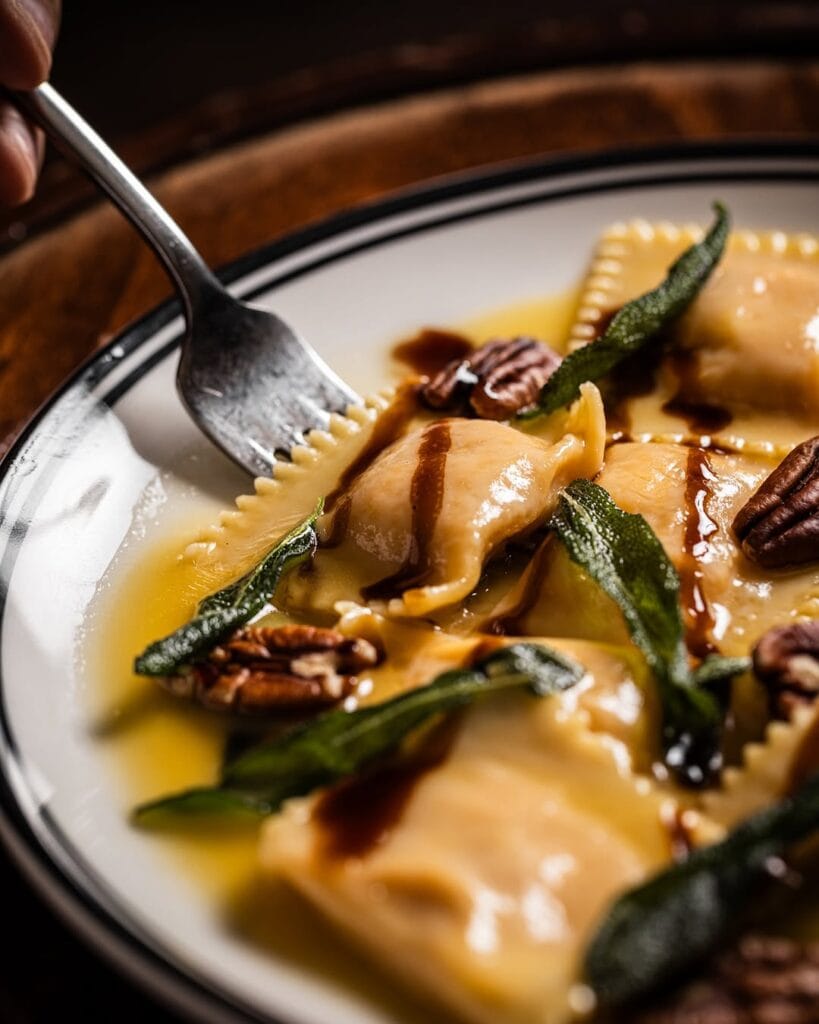 Handmade rav pillows filled with butternut pumpkin, and topped with pecans, crispy sage and little splash of balsamic from Ragazzi