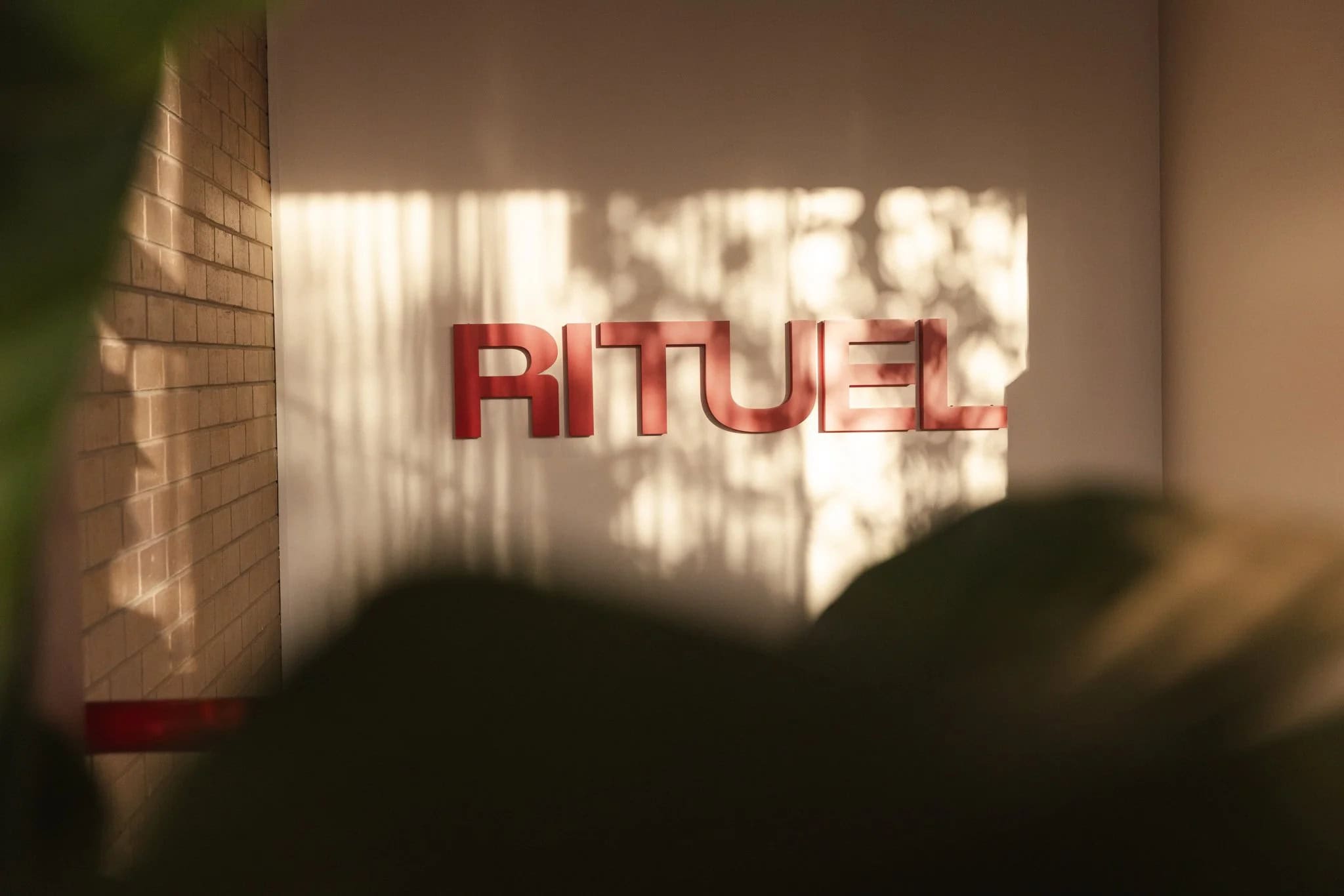 RITUEL signage inside the Fairfield studio, lit by warm afternoon sunlight.