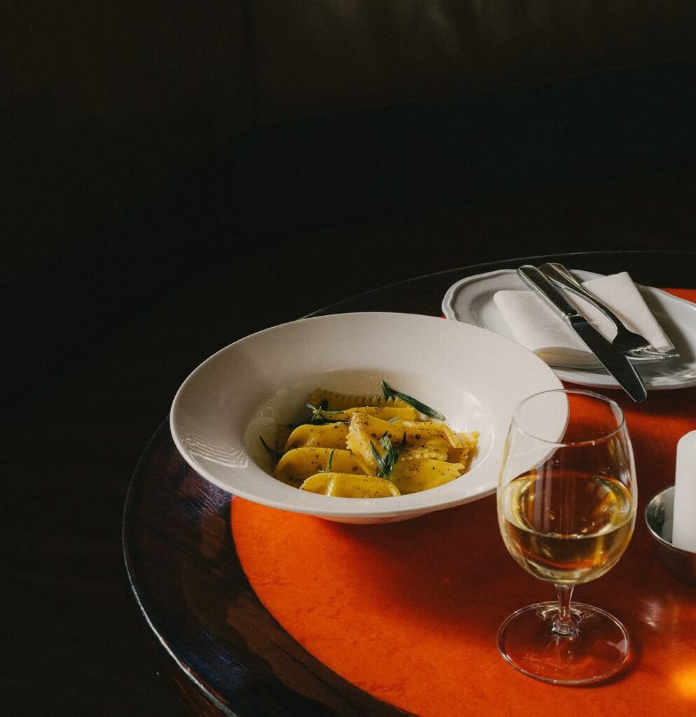 Scallop agnolotti, chicken brodo, black pepper & tarragon from Pellegrino 2000.