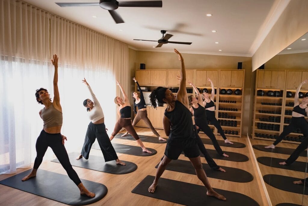 People stretching in a Pilates class at Rodes Studio Fitzroy