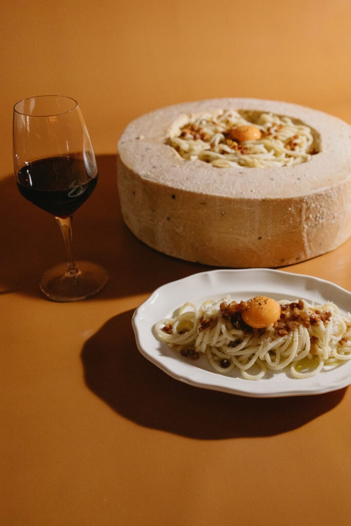 Rovollo pasta offerings with glass of red wine (Image Credit: Christian Michael Photography)