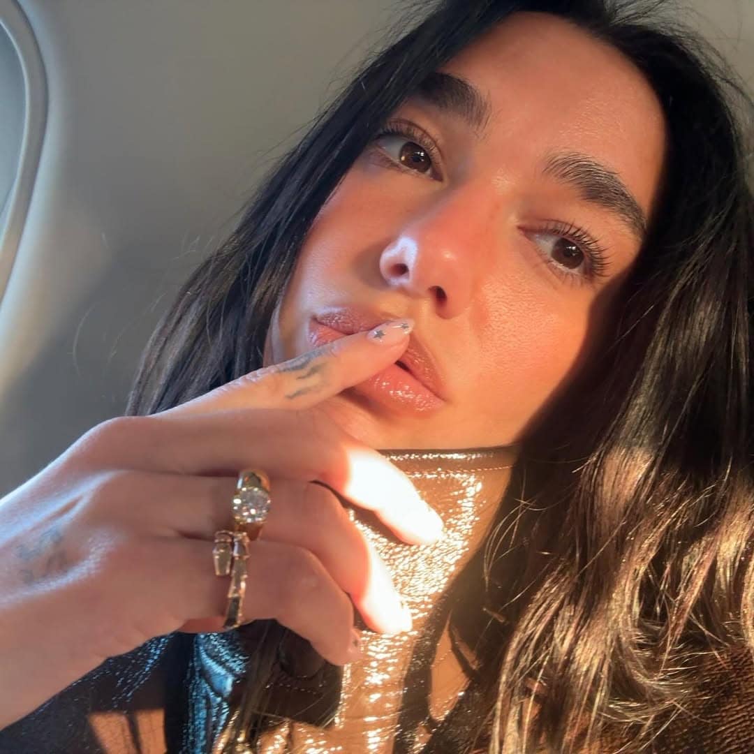 dua lipa showing off her star pattern nails