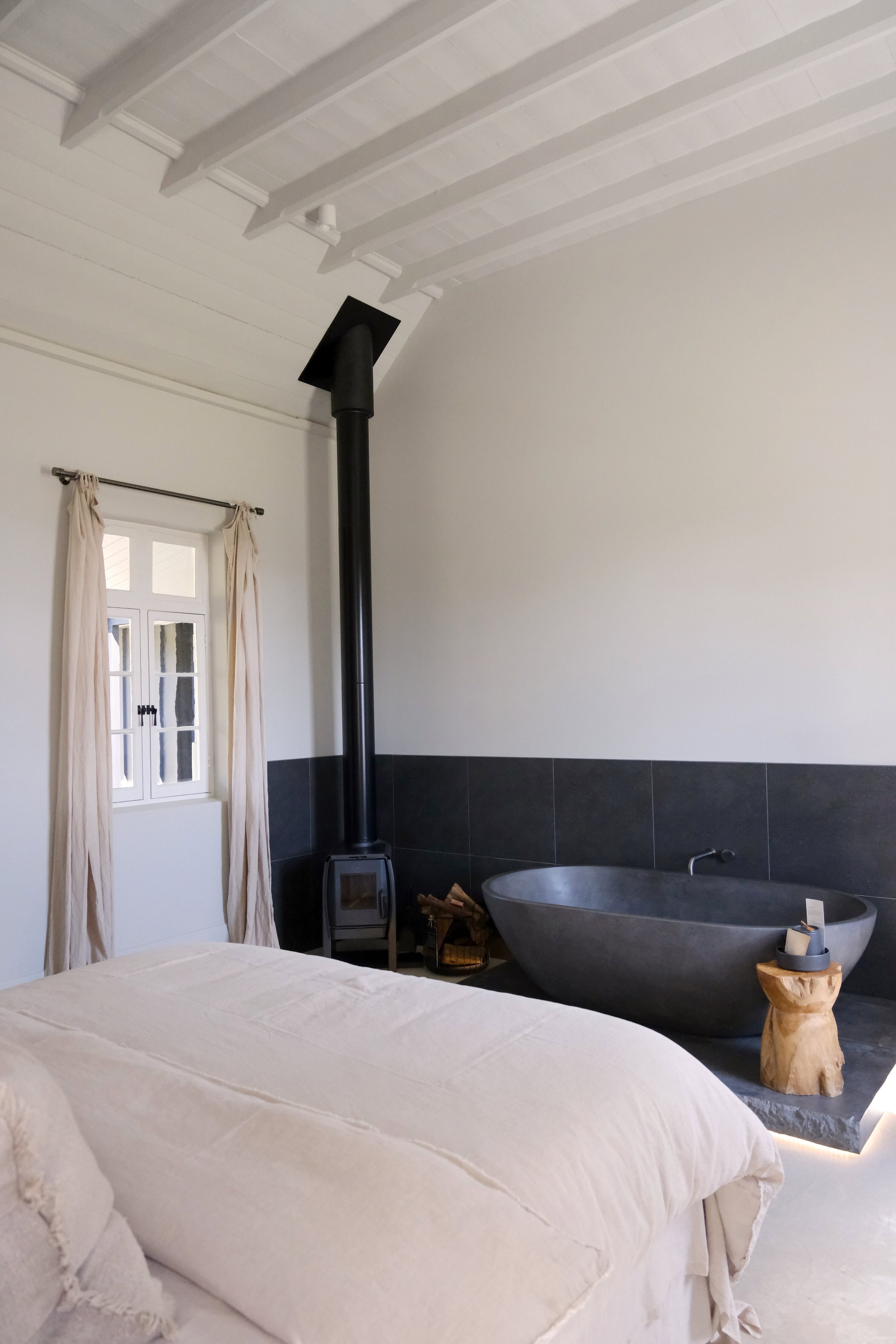 Luxury wellness suite at The Benev in Beechworth with stone bath and fireplace for a High Country babymoon in Victoria.