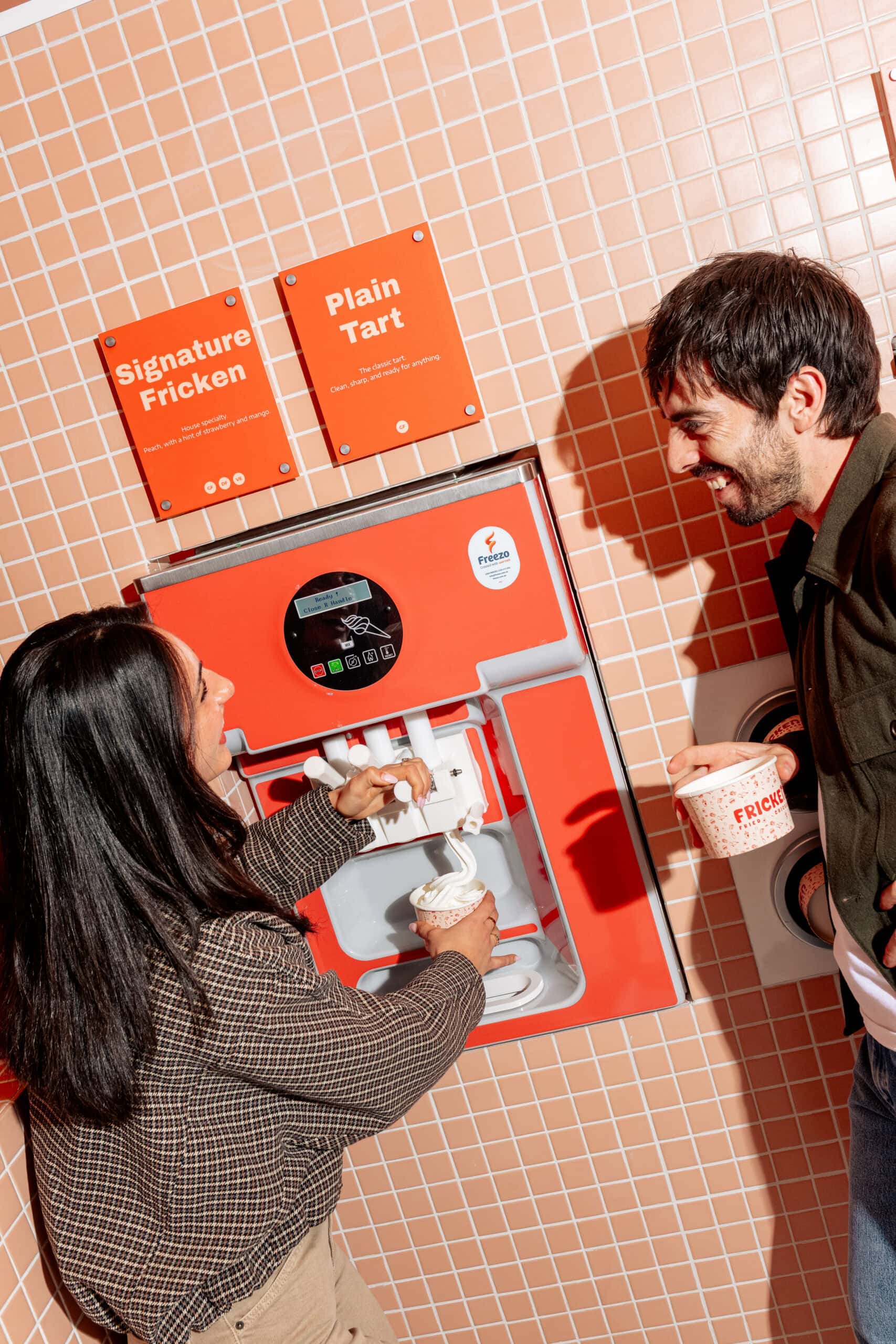 Self-serve frozen yoghurt machine with signature flavour signage at Fricken Canberra