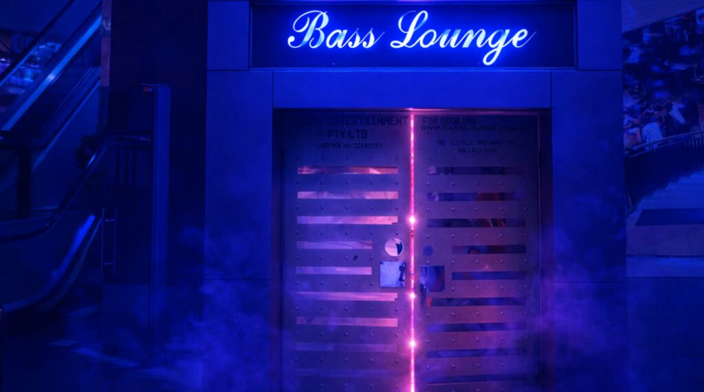 Neon-lit Bass Lounge entrance beneath Paramount Food Court for RISING Melbourne.
