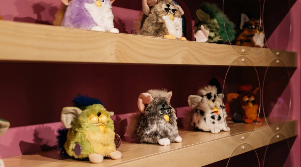 Colourful Furbies displayed on wooden shelves for Furby Chorus and FRIENDs at RISING Melbourne.