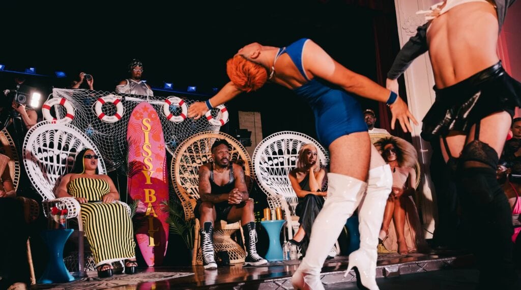 Ballroom dancers performing in front of judges and a crowd for Sissy Ball 8: The Doll House at RISING.