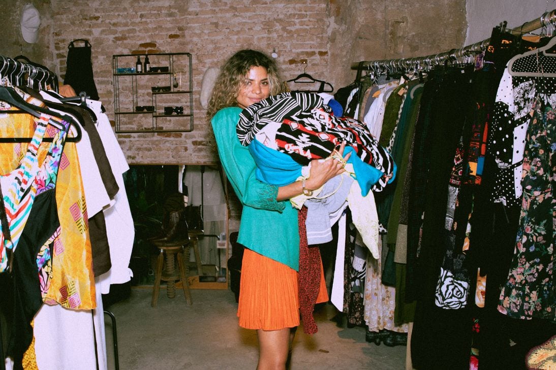 Women holds clothes from warehouse sale.