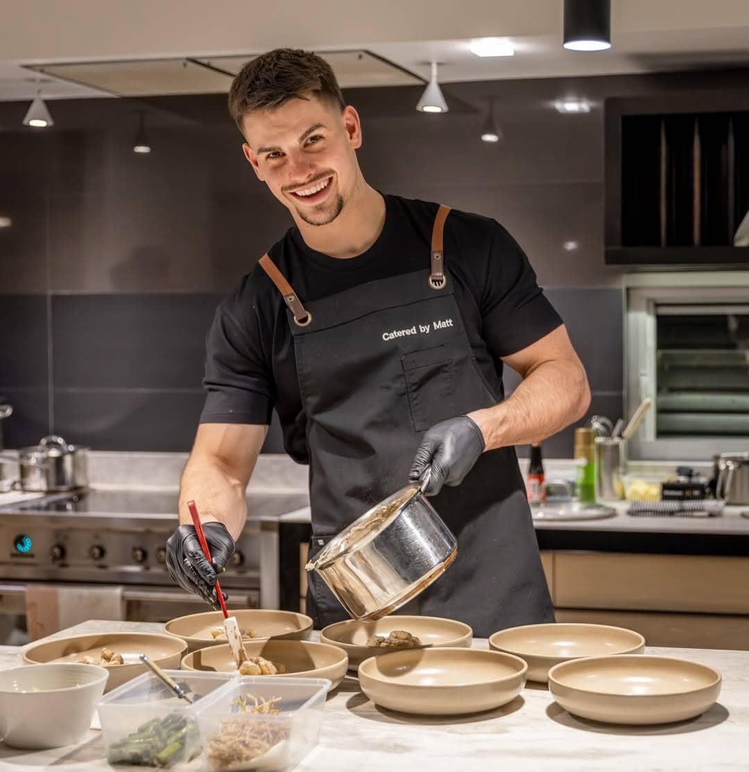 Chef Matt Mirosevich plating dishes in kitchen wearing Catered by Matt apron Sydney