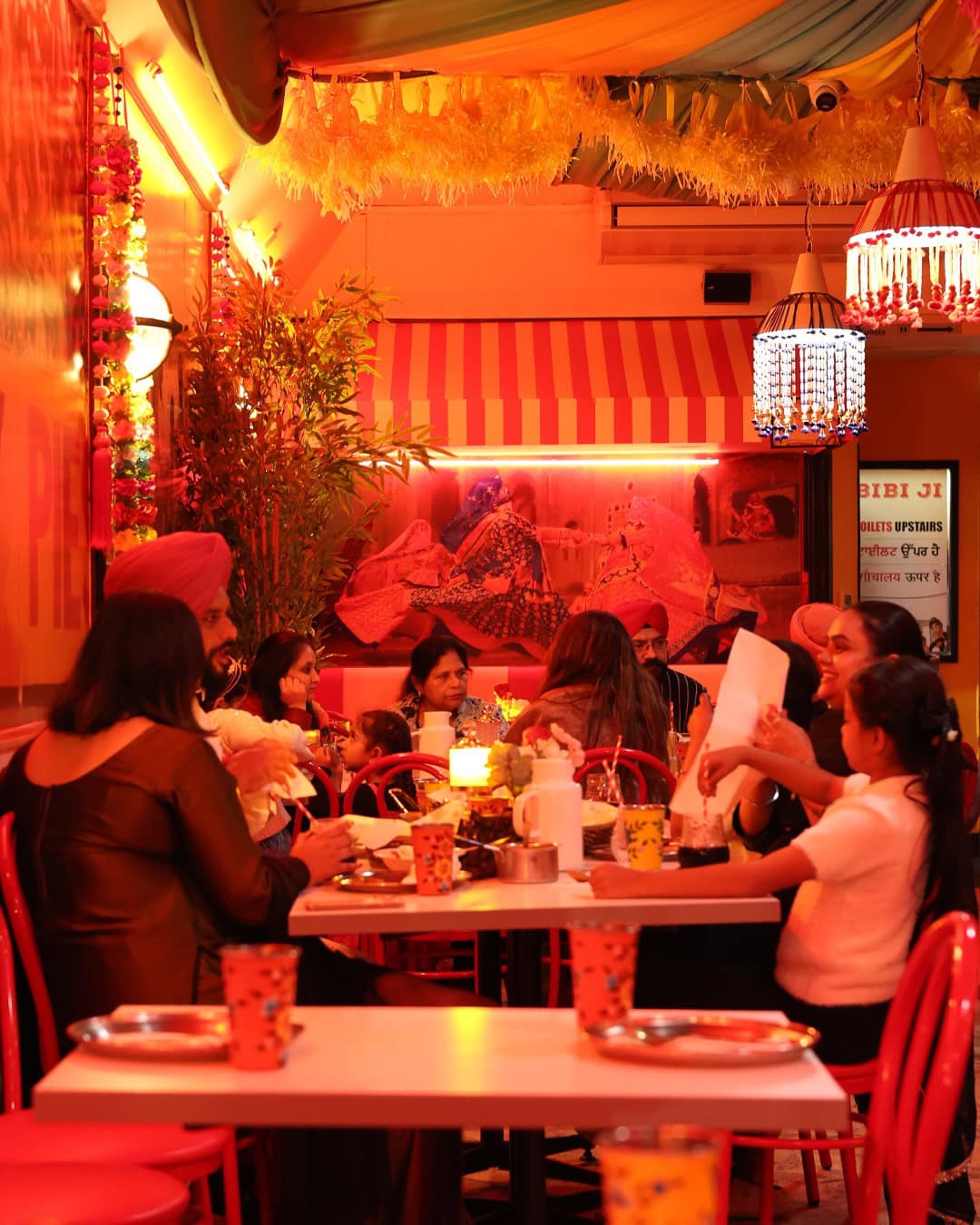 Colourful interior at Bibi Ji in Carlton, with patterned walls, bold seating and a playful Indian diner setting.