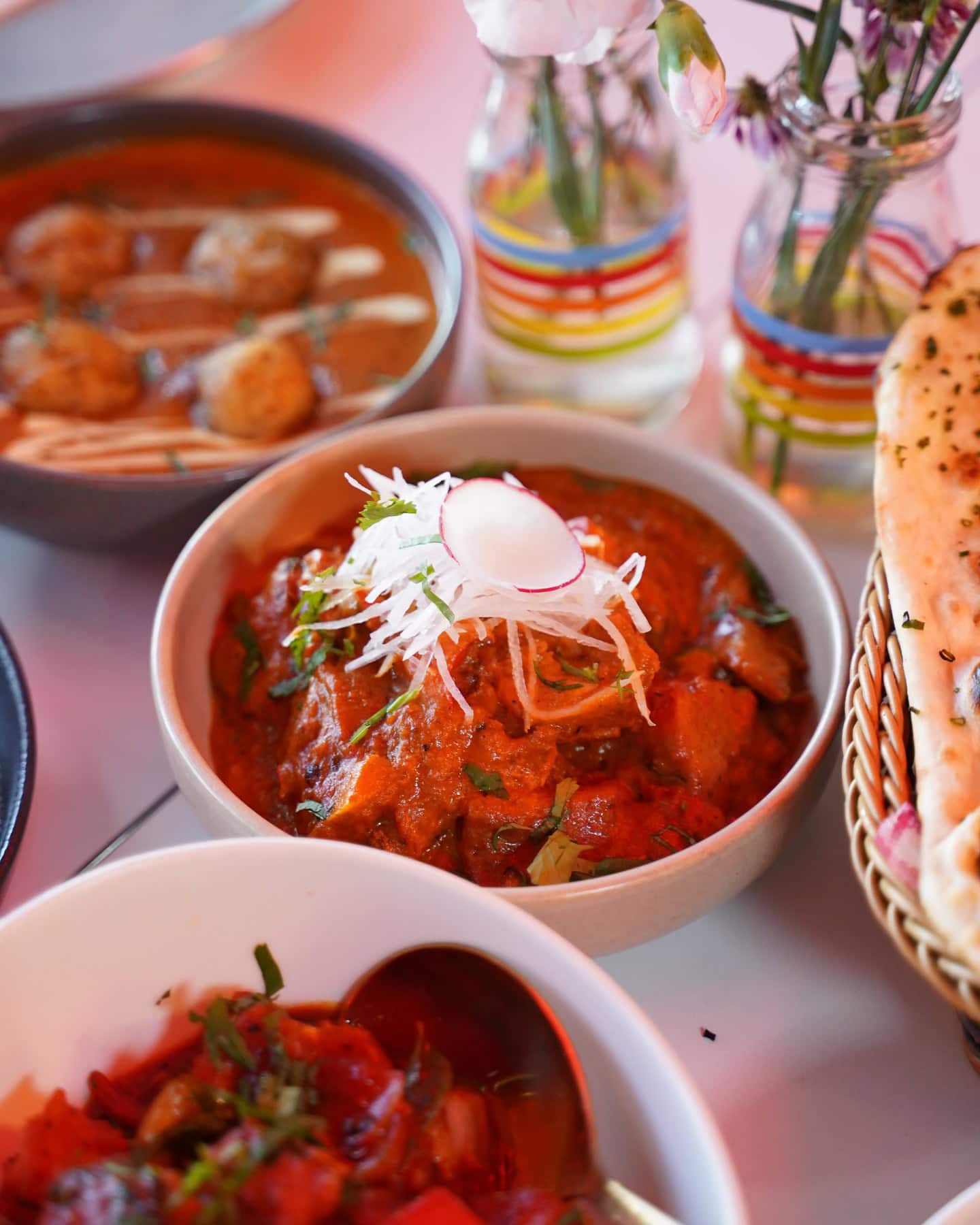 Shared Indian feast at Bibi Ji in Carlton, with thalis, curries, chutneys, rice and drinks across the table.