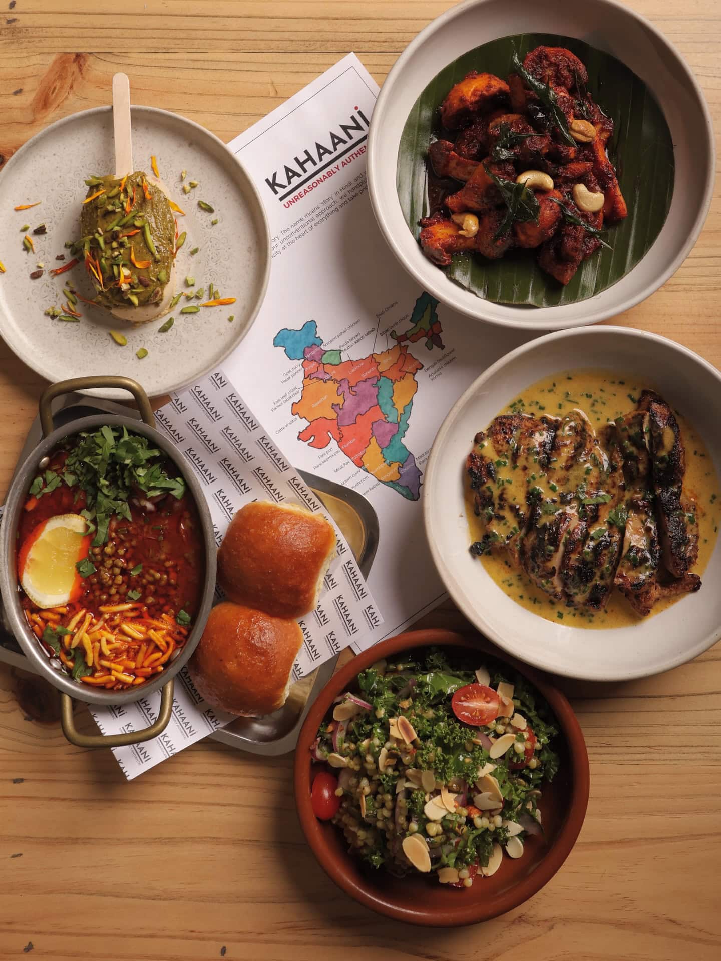 Regional Indian dishes at Kahaani in Carlton, with curries, rice, chutneys and shared plates across the table.